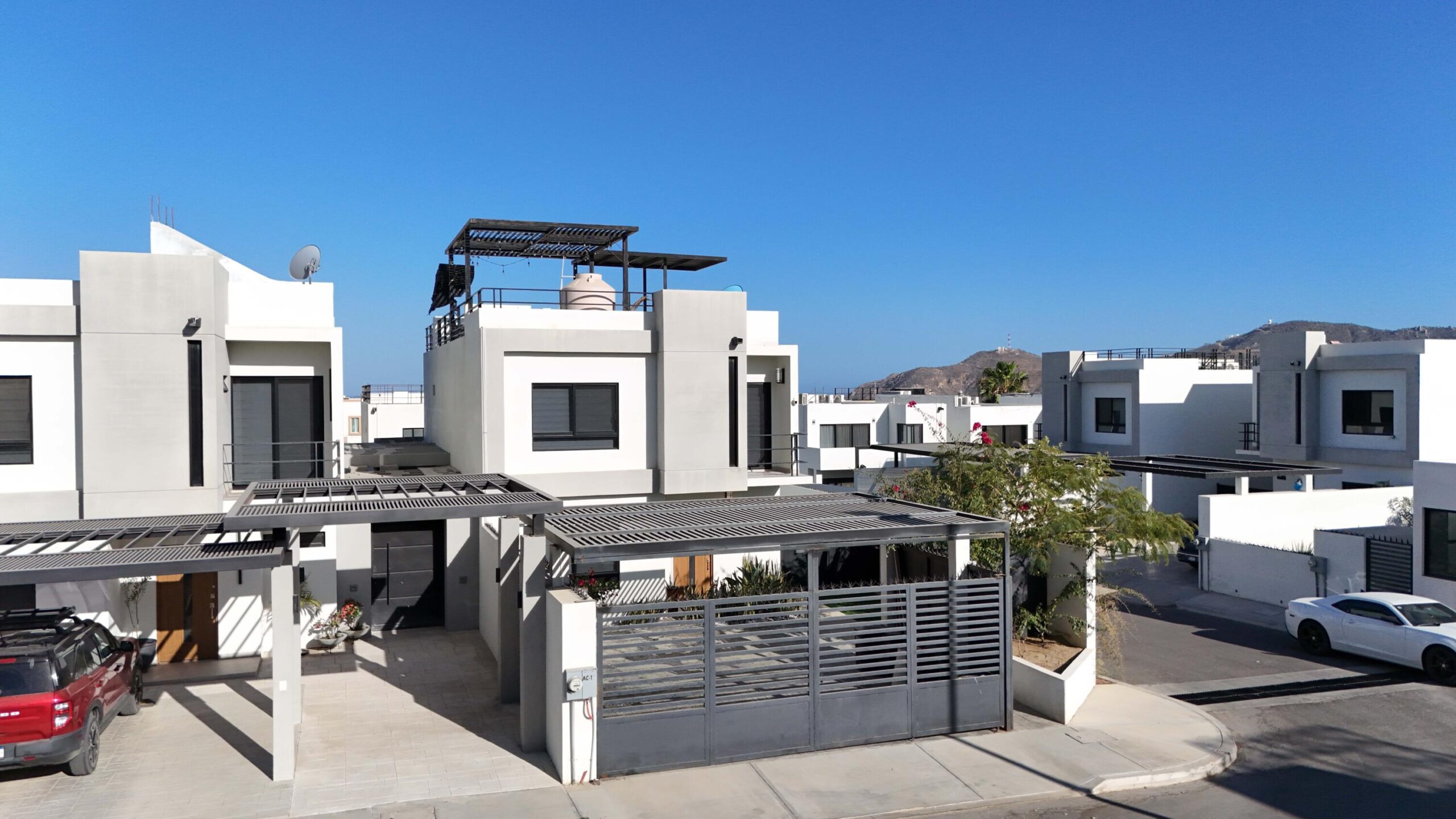 Los Cabos Cumbre Del Tezal Move-in ready and fully furnished. 2,045 sq ft of construction on a 2,551 sq ft lot with 3-car parking. Luxury finishes include marble flooring, wood kitchen with granite countertops, built-in wooden closets in all bedrooms, and vanities with tempered glass shower doors in all 3.5 baths. Fully equipped with 5 Gree inverter mini-split A/C units (3 ร 1-ton, 2 ร 2-ton), LG 22' French Door refrigerator, Whirlpool gas stove, and 1.7 cu ft microwave hood. Additional features: rooftop with bar, grill & sink, private terrace, storage, WiFi smart lock, private 5,000-liter cistern, and termite prevention system. ommunity: pool, gym, sports courts, kids' area, 3 clubhouses & 24/7 gated security for sale